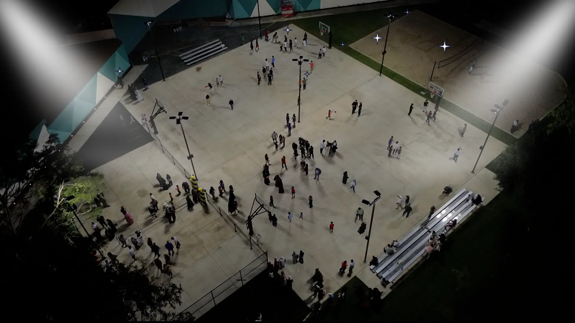 MyDeen community members gathered on an outdoor basketball court at night